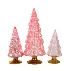 three pink glass christmas trees sitting next to each other