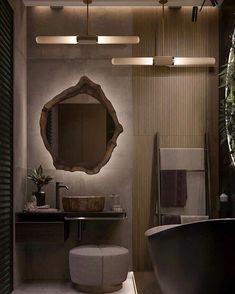 a bath room with a toilet a sink and a mirror on the wall in it