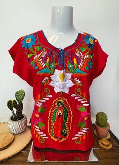 The embroidered design and the color placement may vary due to the handmade nature of each garment. Different patterns and color ensure each piece is handmade and truly one of a kind. No two items are exactly the same. Traditional Cotton Tops With Contrast Embroidery, Bohemian Tops With Machine Embroidery, Red Bohemian Crew Neck Blouse, Traditional Red Top With Geometric Embroidery, Traditional Red Tops With Geometric Embroidery, Red Crew Neck Blouse With Floral Embroidery, Red Folk Tops With Geometric Embroidery, Red Folk Top With Geometric Embroidery, Folk Style Red Tops With Geometric Embroidery