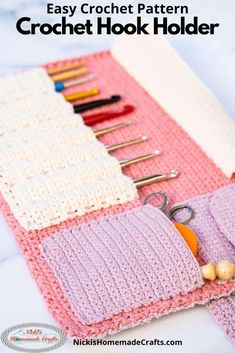 a pink and white crochet purse with scissors, needles, yarns and other crafting supplies