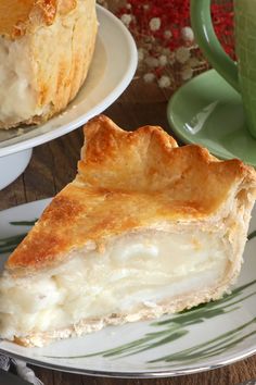 a piece of pie sitting on top of a plate next to a cup and saucer