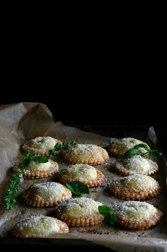 some food that is sitting on top of a tray with leaves and powdered sugar