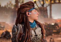 a woman with dreadlocks standing in the desert