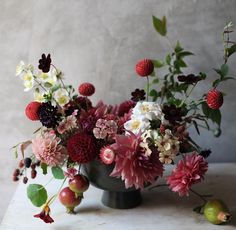 a vase filled with lots of different types of flowers