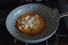 a pan filled with food sitting on top of a stove