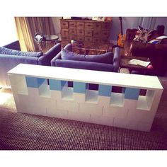 a living room with blue couches and a white table in the middle of it