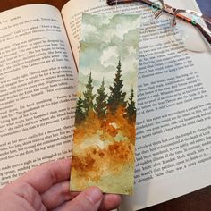 an open book with a watercolor painting on it