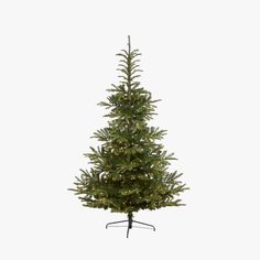 a small christmas tree with lights on it's top and bottom branches, in front of a white background