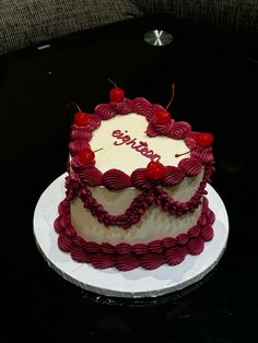 a white and red cake sitting on top of a table