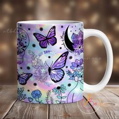 a white coffee mug with purple butterflies and flowers painted on it, sitting on a wooden table