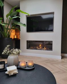 a living room with a fireplace and candles on the table