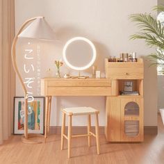 a wooden desk topped with a mirror and a stool next to a lamp on top of a hard wood floor