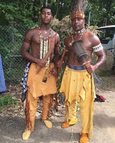 two men dressed in native clothing standing next to each other