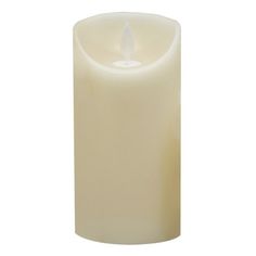 a white candle is lit on a white background