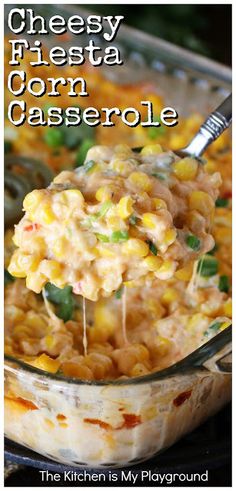 cheesy fiesta corn casserole in a glass dish with a spoon