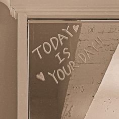 a sign that says today is your day written on the side of a building window