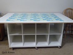 a white table with several shelves on each side