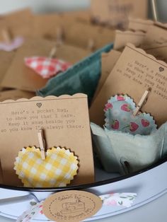 several small cupcakes are sitting on a plate with clothes pins attached to them