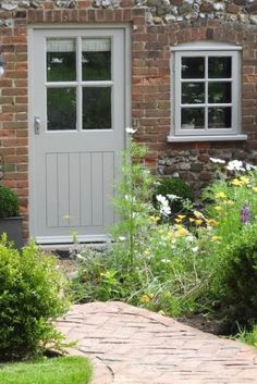 a brick house with white doors and windows