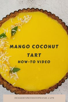 there is a pie with coconut on top and the words mango coconut tart below it