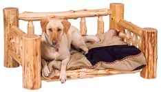 a dog laying on top of a bed made out of wooden posts and logs with a blanket