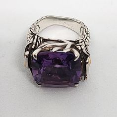 This Large Amethyst Cocktail Ring Is Set In The Most Gorgeous Design I've Ever Seen John Hardy Create In A Ring. The Ring Is Completed Of Two Dragons That Curl Up Around Your Finger And Emit Flames Out Of Their Mouth, Wrapping The Ring Completely And Becoming The Prongs That Hold This Gorgeous Amethyst Stone. Inside The Ring Is More Beautiful Artwork Where The Dragon Is Laid Out Against The Stone. An Absolute Epic Ring. I've Had This In London Blue, Citrine, And Amethyst, And I've Gotten So Many Compliments Every Time I Wear Them. You're Going To Love It. The Ring Is Sterling Silver With Some 18 Karat Gold Detailing Including The Dragon's Eyes. This Is A Size 7 According To John Hardy. Howe Two Dragons, Amethyst Cocktail Ring, Dragon Eye, John Hardy, London Blue, Amethyst Stone, Gorgeous Design, The Dragon, Cocktail Ring