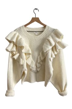 Details Make a statement this fall with the ruffled Versace in Mind Sweater in ivory. Large knit ruffles form a v-shape down the front and around the shoulders, made with the softest knit material. Pair this sweater with your favorite floral skirt or tuck it into high-waisted pants for a chic outfit! Knit ruffle detailing Crew neckline Ribbed cuffs and hemline Color: Cream Fabric + Fit 70% Acrylic, 27% Nylon, 3% Spandex Fit is true to size XS (2-4), S (6-8), M (10-12), L (12-14) Imported Measure Sweater With Ruffles, Coquette Dress Outfit, Hyper Feminine Outfits, Knit Ruffles, Outfit Knit, Hyper Feminine, Church Clothes, Feminine Outfits, Preppy Fashion