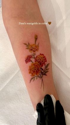 a woman's arm with flowers on it and the words, don't margolds in color