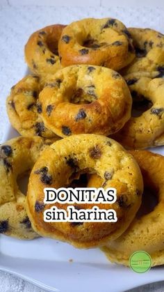 several donuts on a white plate with the words donas sin harrina