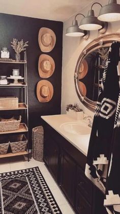 a black and white rug in a bathroom next to a sink with a mirror above it