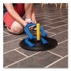 a child playing with a toy on the floor