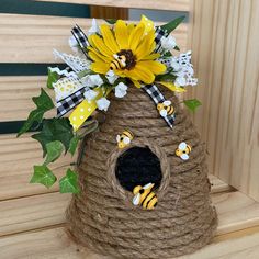 a birdhouse with flowers and bees on it