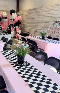 the tables are decorated with pink, black and white decor for an event or party