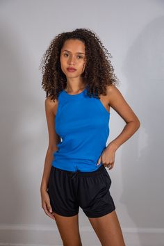 The "IT" tank. The tank top of all tank tops – designed with lasting quality fabrication and ribbed texture. The perfect elevated basic to dress up or down. She does it all! Blue Athleisure Top With Tank Straps, Blue Seamless Racerback Top, Blue Ribbed Tank Top For Workout, Ribbed Sleeveless Workout Tops, Ribbed Sleeveless Tops For Workout, Spring Ribbed Tank Top For Gym, Ribbed Racerback Tank Top For Gym, Ribbed Tank Top For Gym, Ribbed Tank Top For Workout