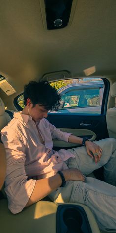 a man sitting in the back seat of a car with his foot on the floor