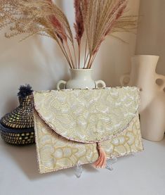 Golden evening clutch golden wedding clutch clutch bag small shoulder strap designer bag. Our Daardart clutch is the combination of chic style, originality and uniqueness. It is the ideal choice to add a touch of elegance and sophistication to your evening or wedding outfits. Made from carefully selected upholstery fabric scraps, each pouch is one of a kind. The satin lining adds a touch of comfort and elegance, while the snap closure helps keep your belongings secure. The clutch can be carried Beige Envelope Clutch For Party, Beige Envelope Clutch For Evening, Elegant Beige Clutch For Gift, Elegant Beige Clutch As Gift, Beige Clutch Evening Bag For Wedding Guest, Beige Envelope Evening Bag, Envelope Clutch For Wedding Guest, Chic Gold Clutch For Events, Beige Pouch Clutch For Events