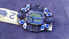 Lovely brooch with deep blue colors. Designed with blue enamel guilloche leaves and small glass accents. Small amount of wear in pin backing. On the first picture top right there is a small amount of wear to the blue of the enamel but the white is still intact. Great working clasp. Good vintage condition with very little wear. Center stone is open work and prong set where the chaton accents on the sides are bevel set into the piece. This line was designed by Neiger Brothers and showcases the uni Ornate Blue Brooches For Wedding, Formal Blue Enamel Brooches, Ornate Blue Wedding Brooches, Antique Blue Enamel Brooches, Bohemian Art, Sterling Silver Brooch, Enamel Brooch, Silver Art, Silver Brooch