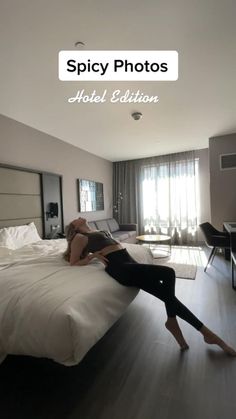 a woman laying on top of a bed in a hotel room