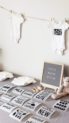 a baby's first birthday party with onesie hanging on clothesline and teddy bear