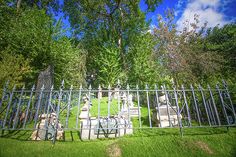 a cemetery with many headstones and trees in the background