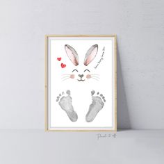 a framed print with an animal's footprints and hearts on the bottom right hand side