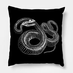 a black and white pillow with an image of a snake in the middle of it