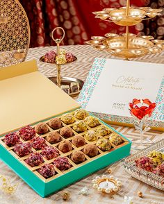 a table topped with boxes filled with different types of candies and sweets on top of a table