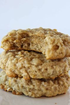 three oatmeal cookies stacked on top of each other in front of a white background