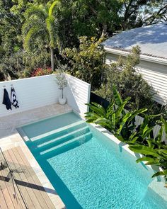 an empty swimming pool surrounded by greenery