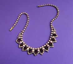 A Glamorous Edwardian Style necklace. Decadent and sparkly, a really nice quality necklace to be worn on that special occasion. Contrasting clear diamante and amethyst coloured stones. (All as shown in the photographs) Elegant, regal and timeless. Gorgeous bridal accessory or to be worn where you will. A glamourous design that sits on the neckline really well. Condition: Very good vintage condition, no damage or flaws. All stones in place. Length is 18.0 inches long Packed with care Wrapped in t Purple Jeweled Necklace For Party, Purple Rhinestone Necklace For Wedding, Purple Sparkling Stone Necklaces For Wedding, Purple Rhinestone Wedding Necklace, Purple Sparkling Stones Necklace For Wedding, Purple Jeweled Necklace For Formal Occasions, Formal Purple Jeweled Necklace, Purple Rhinestone Necklace For Gift, Gift Rhinestone Necklace With Sparkling Stones