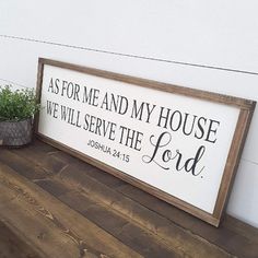 a wooden sign that says as for me and my house we will serve the lord