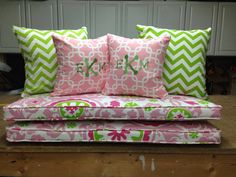 pink and green pillows with monogrammed letters on them