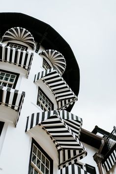 an unusual building with black and white stripes on it