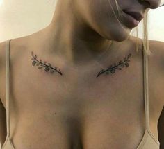 a woman's chest with two small tattoos on her left shoulder and the upper part of her breast